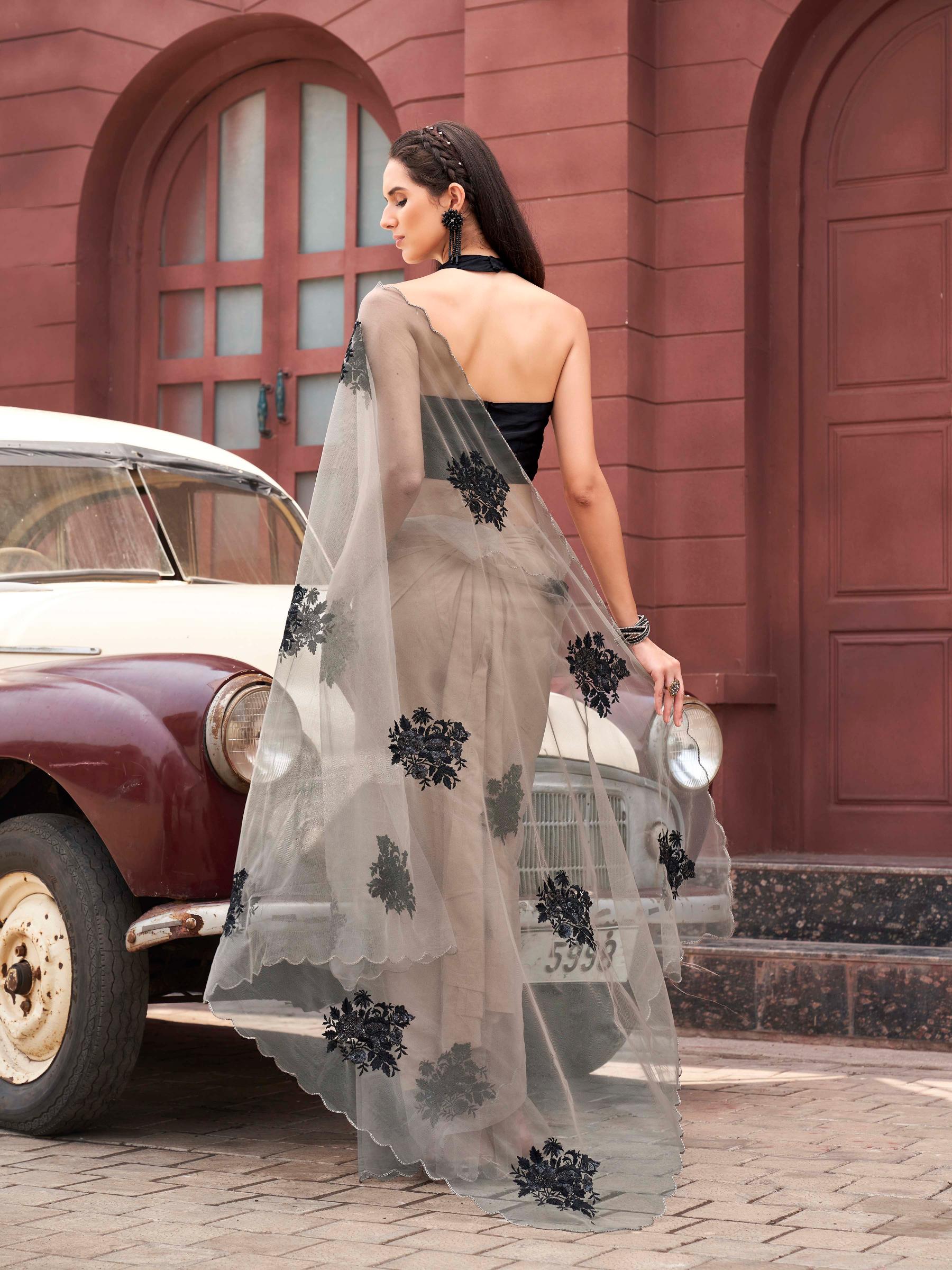 Tan colored embroidered net saree with scalloped border